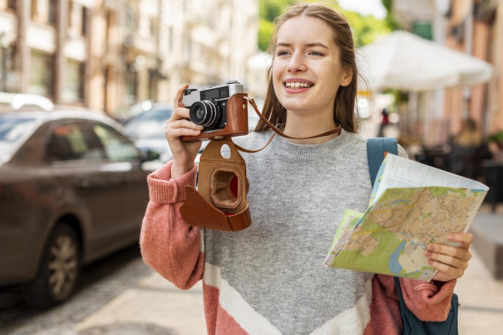 Zdjęcie dziewczyny z aparatem fotograficznym i mapą.